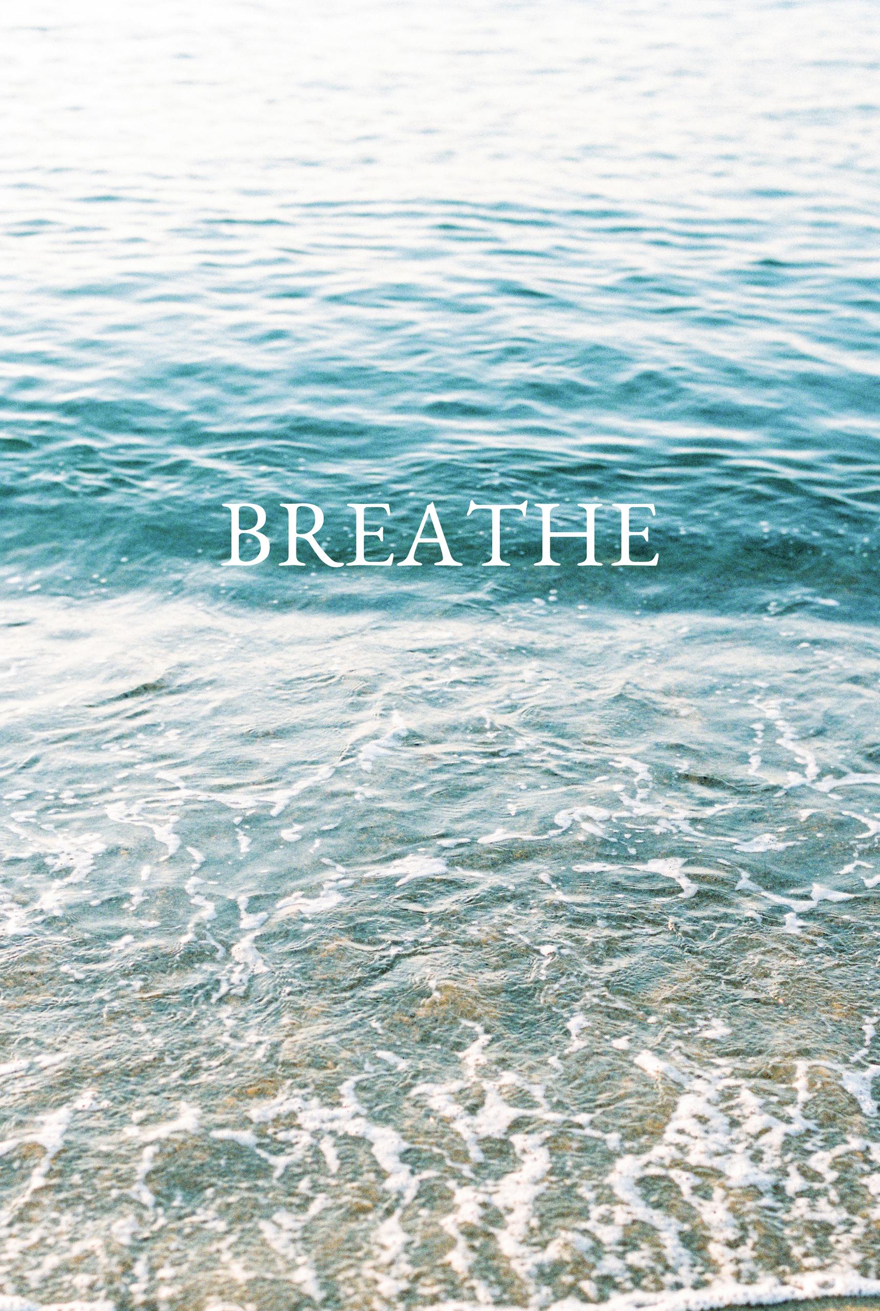 Serene ocean waves with 'Breathe' text inspire calm and reflection.
